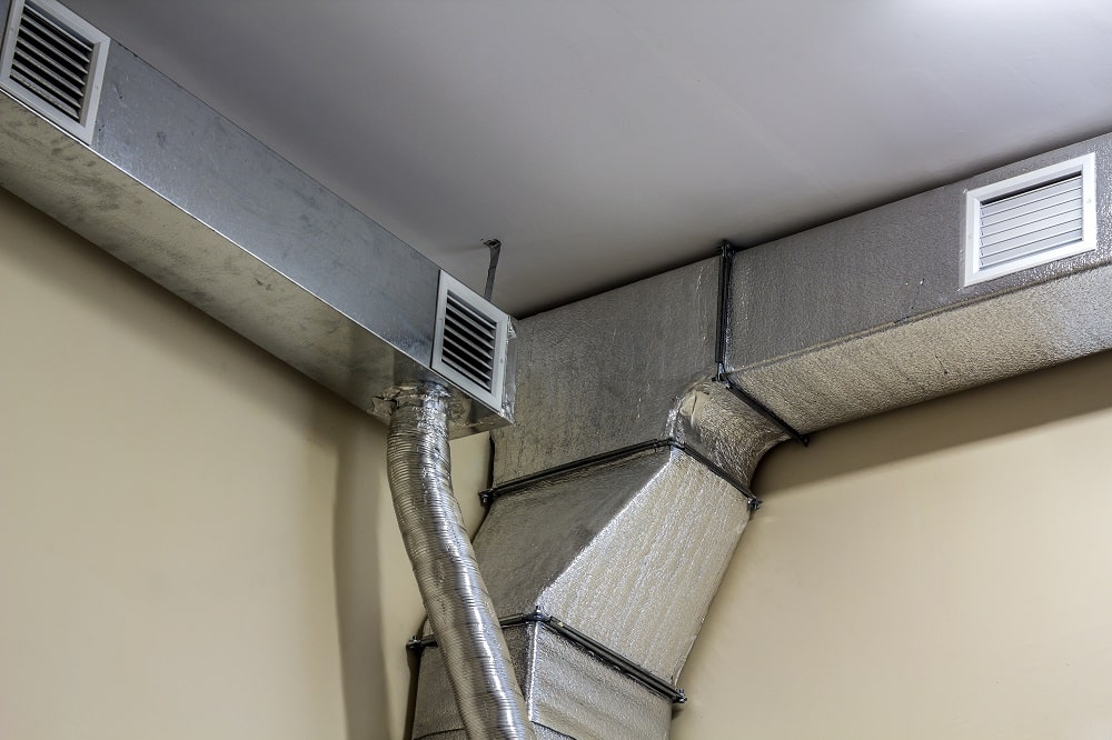 Industrial air duct ventilation equipment and pipe systems installed on a building ceiling in New Orleans