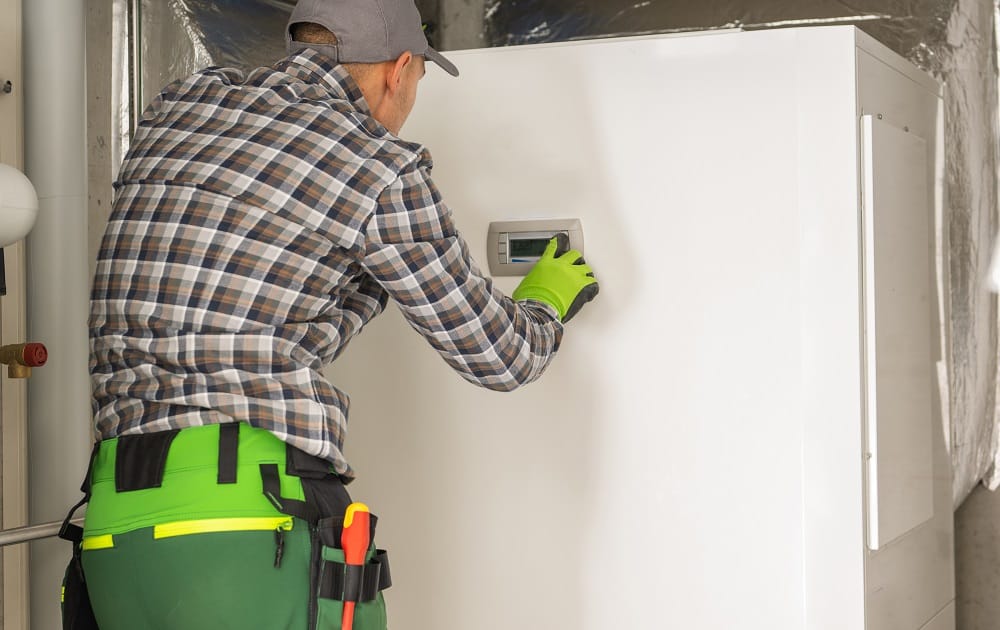 LSLBC-licensed technician performing residential heat pump installation and adjustment in a New Orleans area home.