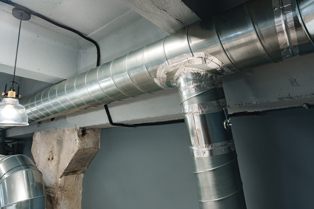 Silver ventilation pipes hanging from the ceiling inside a New Orleans area home close up