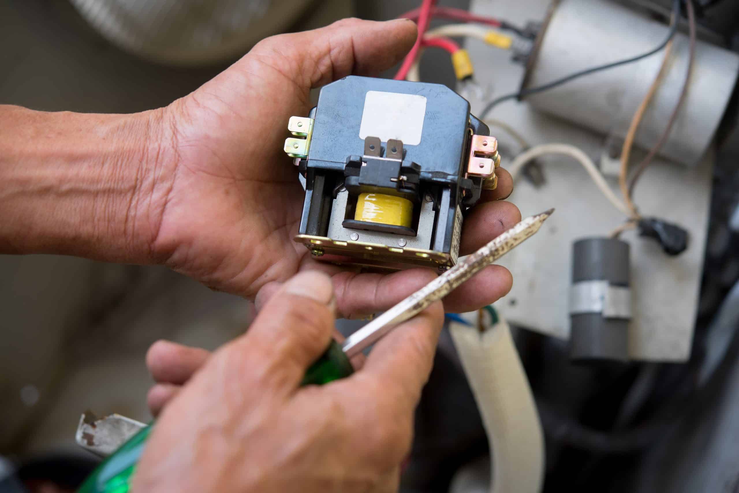 AC capacitor repair close up HVAC component