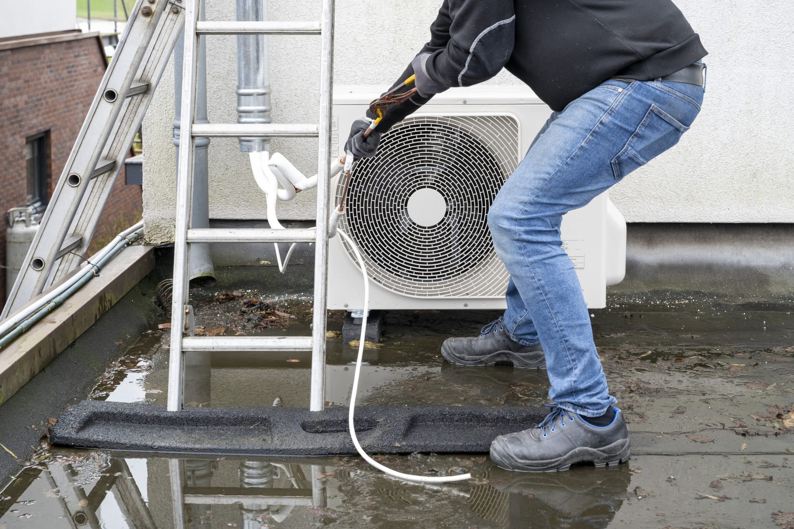 technician checking AC system condensate drain