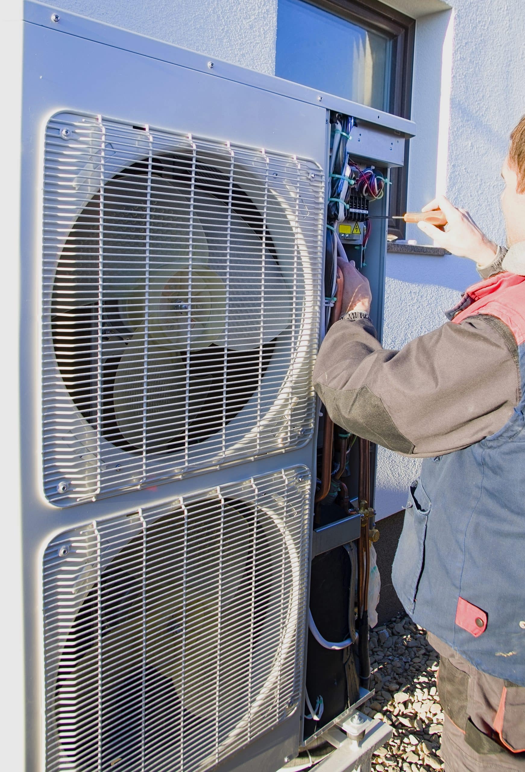 technician removing old AC unit outdoor condenser